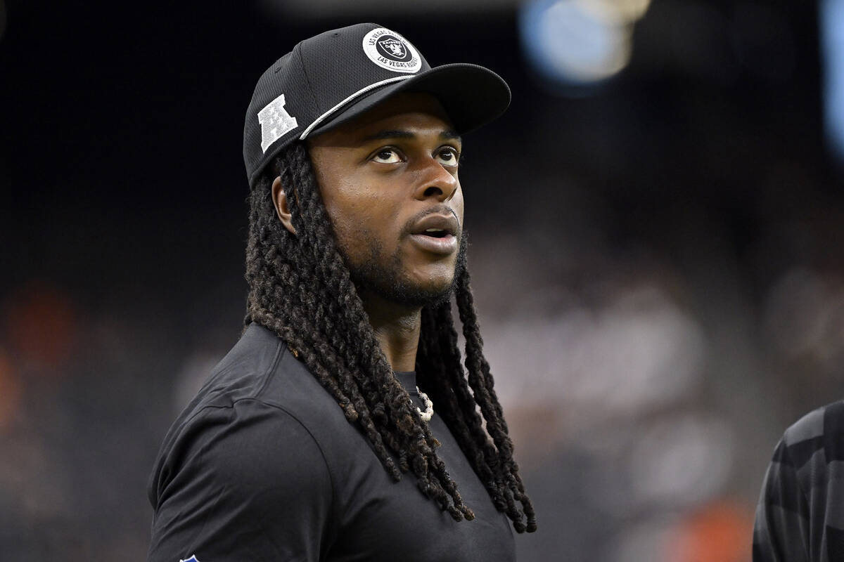 Las Vegas Raiders wide receiver Davante Adams looks on before an NFL football game between the ...