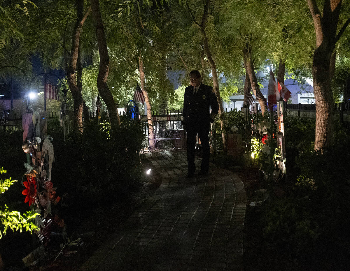 Las Vegas Fire and Rescue Senior Deputy Fire Chief Robert Nolan walks along a path lined with r ...