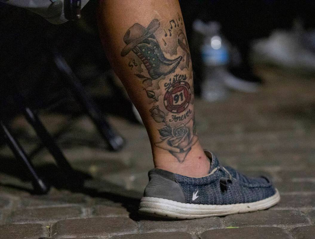 A mourner with a tattoo to remember those who perished during the events of Oct. 1, 2017, atten ...