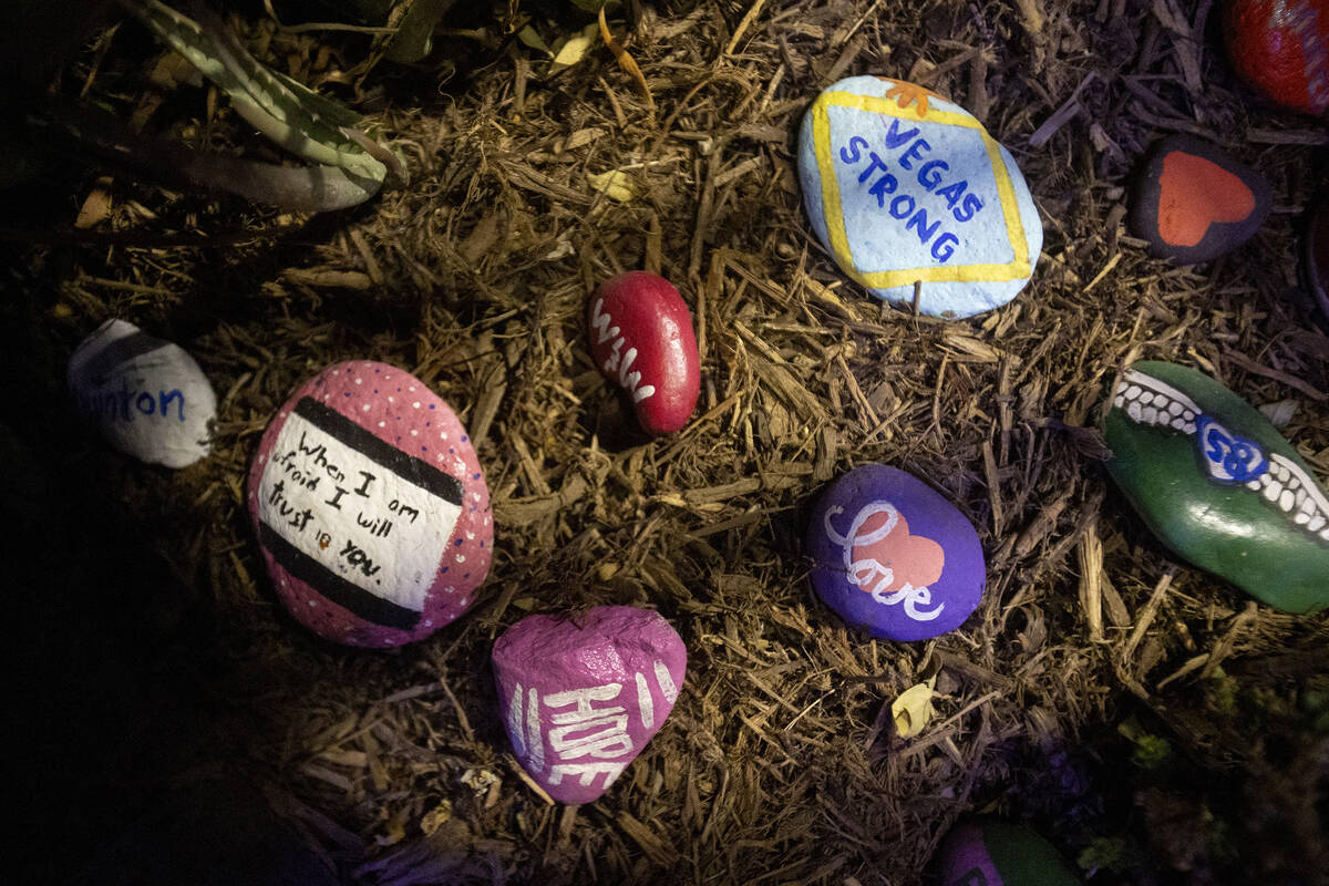 Painted rocks are placed throughout the garden to remember those who perished during the events ...