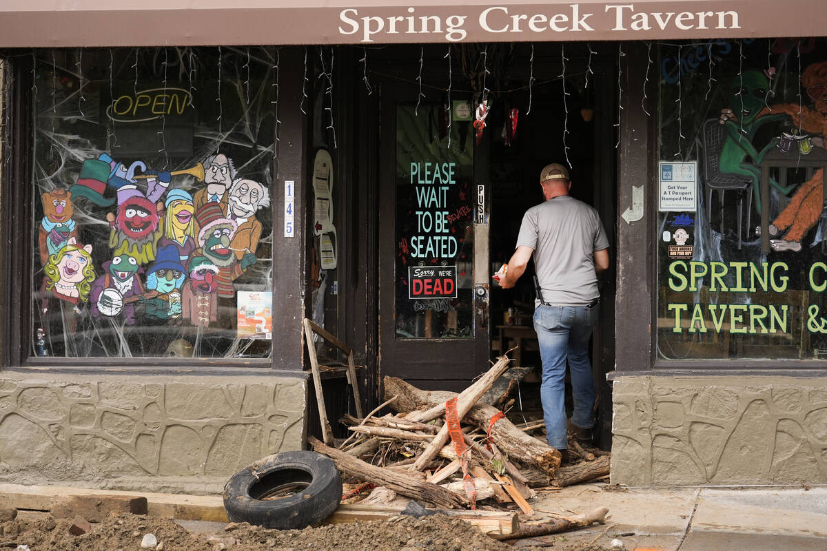 A person enters a heavily damaged building as clean up in the aftermath of Hurricane Helene beg ...