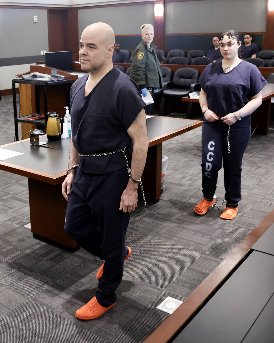 Robert Telles, center, walks out of court before a hearing at the Regional Justice Center in La ...