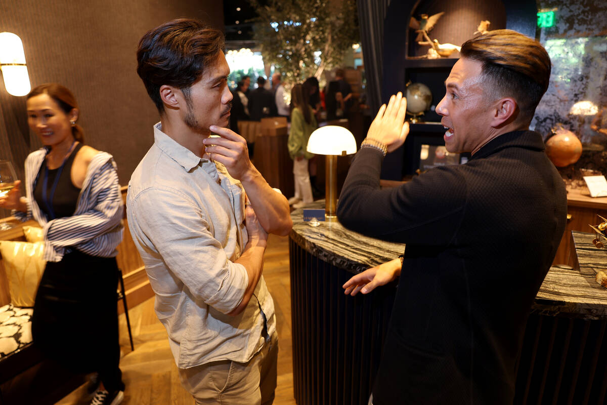 Kent Yoshimura, co-founder and CEO at NeuroGum and Mints, left, talks with former Olympic champ ...