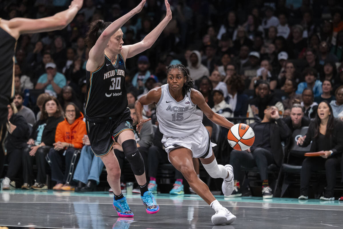 Las Vegas Aces guard Tiffany Hayes (15) is defended by New York Liberty forward Breanna Stewart ...