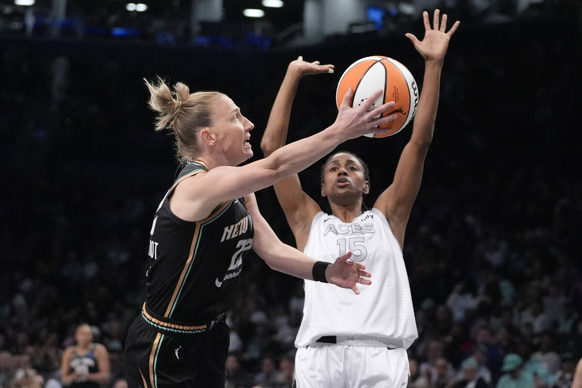 New York Liberty's Courtney Vandersloot (22) shoots over Las Vegas Aces' Tiffany Hayes (15) dur ...