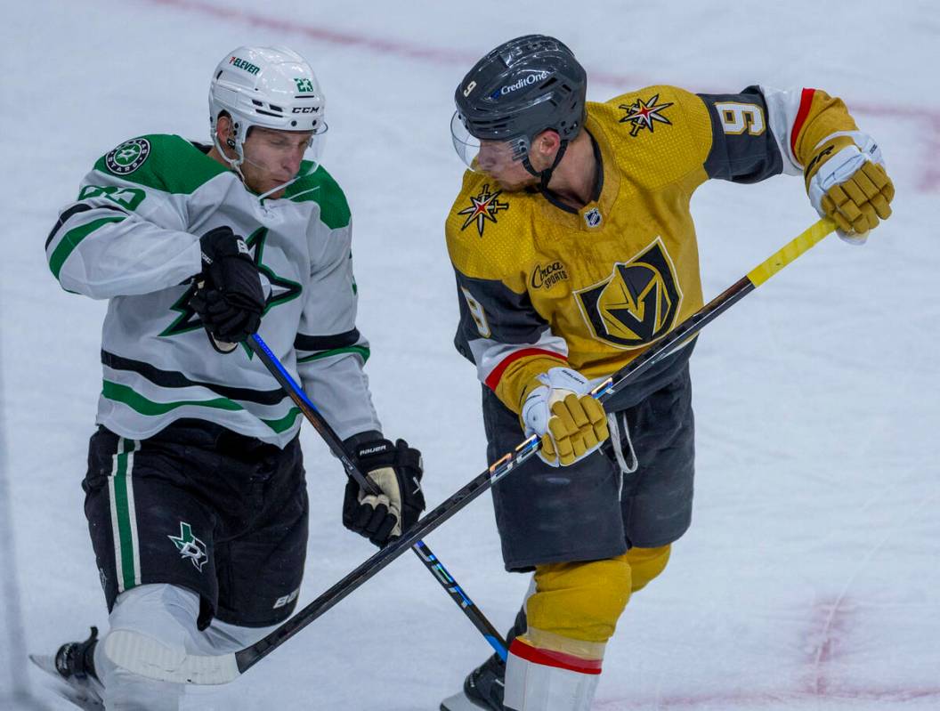 Golden Knights center Jack Eichel (9) and Dallas Stars defenseman Esa Lindell (23) fight for po ...