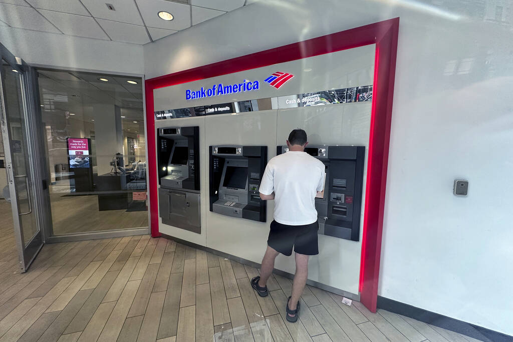 A person uses a Bank of America ATM in New York on Friday, August 2, 2024. (AP Photo/Ted Shaffrey)