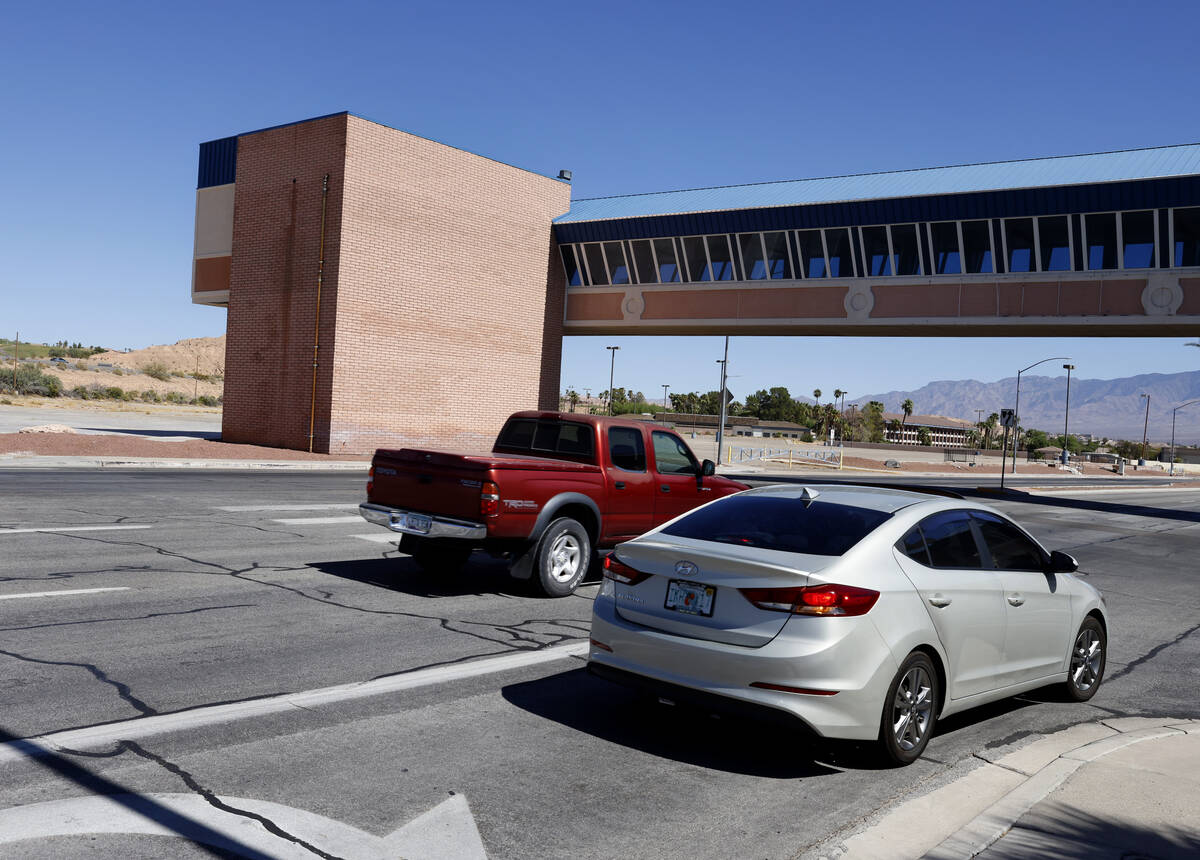 Motorists drive under the former Oasis Casino Resort's pedestrian bridge, on Tuesday, Sept. 24, ...