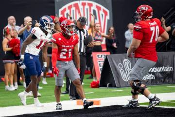 UNLV wide receiver Jacob De Jesus (21) celebrates after scoring a touchdown during the college ...