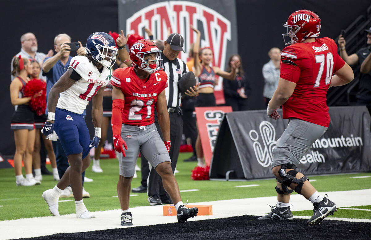 UNLV wide receiver Jacob De Jesus (21) celebrates after scoring a touchdown during the college ...