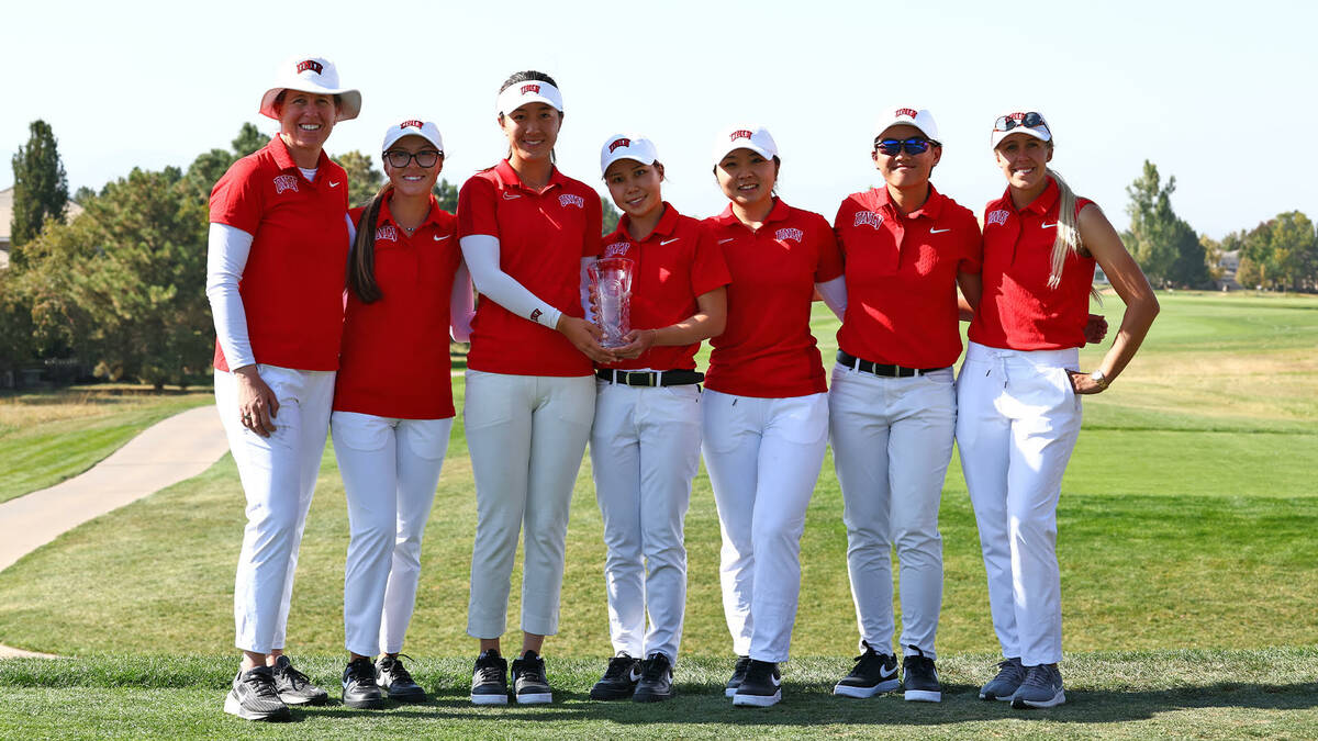 UNLV players and coaches pose with the championship trophy after winning the Ron Moore Intercol ...