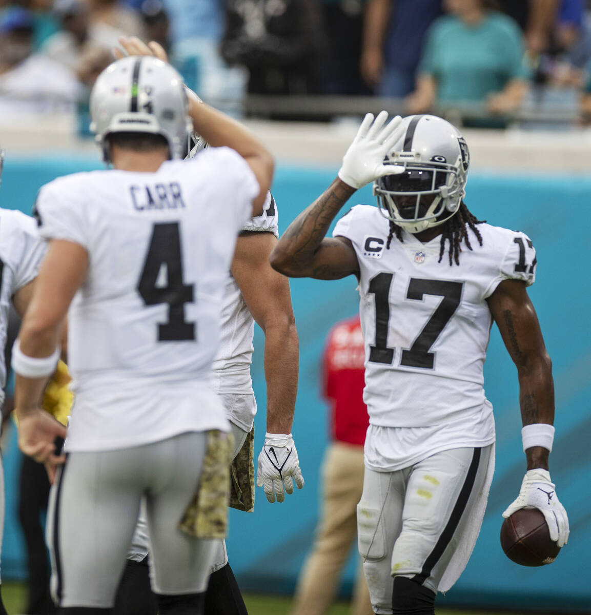 Raiders wide receiver Davante Adams (17) celebrates his touchdown with Raiders quarterback Dere ...