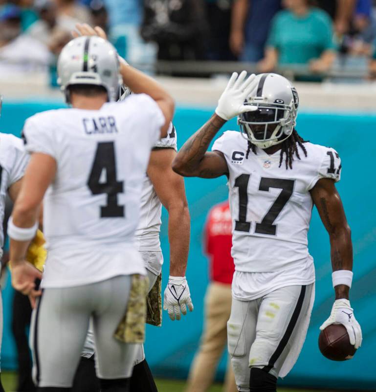 Raiders wide receiver Davante Adams (17) celebrates his touchdown with Raiders quarterback Dere ...