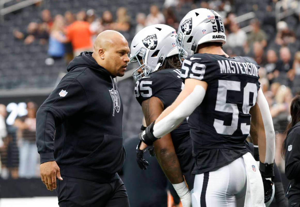 Raiders head coach Antonio Pierce greets defensive tackle John Jenkins (95) and linebacker Luke ...