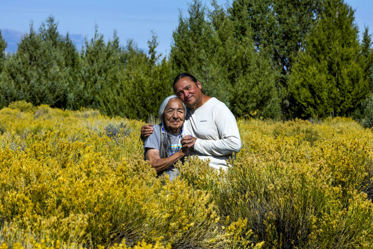 Delaine and Rick Spilsbury stand among Bahsahwahbee, a grove of Rocky Mountain juniper trees lo ...