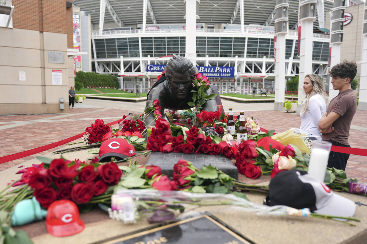 Jodi and Landon Funky, 17, right, both of Independence Ky., visit the statue of Cincinnati Reds ...