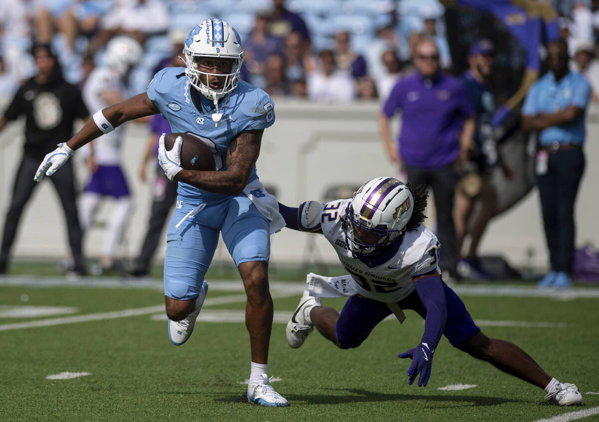 North Carolina wide receiver Kobe Paysour (8) escapes from James Madison cornerback DJ Barksdal ...