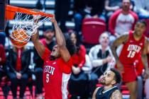 UNLV Rebels forward Rob Whaley Jr. (5) dunks the ball as UNR forward K.J. Hymes (42) looks on d ...