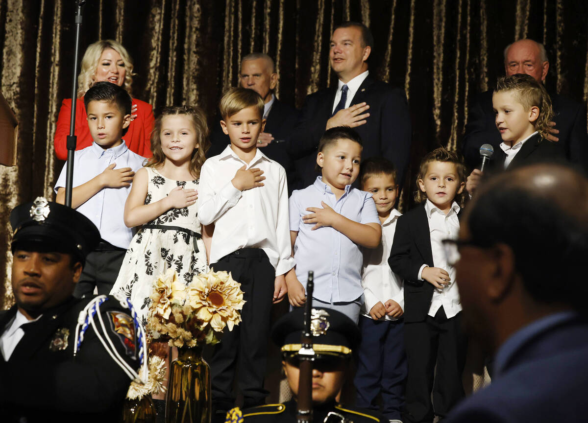 Henderson Mayor Michelle Romero, top left, watches as her grandchildren recite the Pledge of Al ...