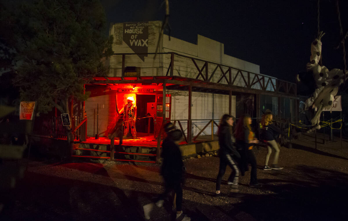 People pass by an attraction during "Bonnie Screams" at Bonnie Springs Ranch outside of Las Veg ...