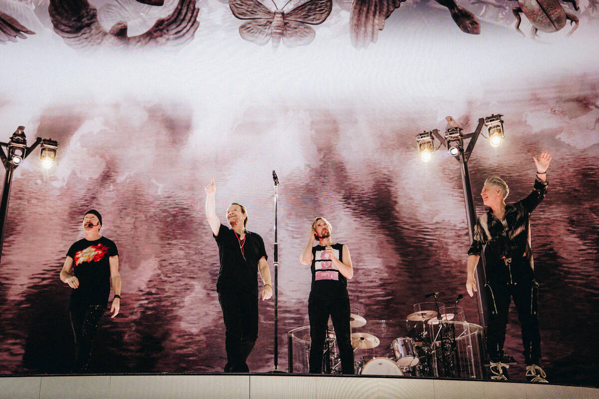 The Edge, from left, Bono, Bram van den Berg and Adam Clayton salute the audience during U2's S ...