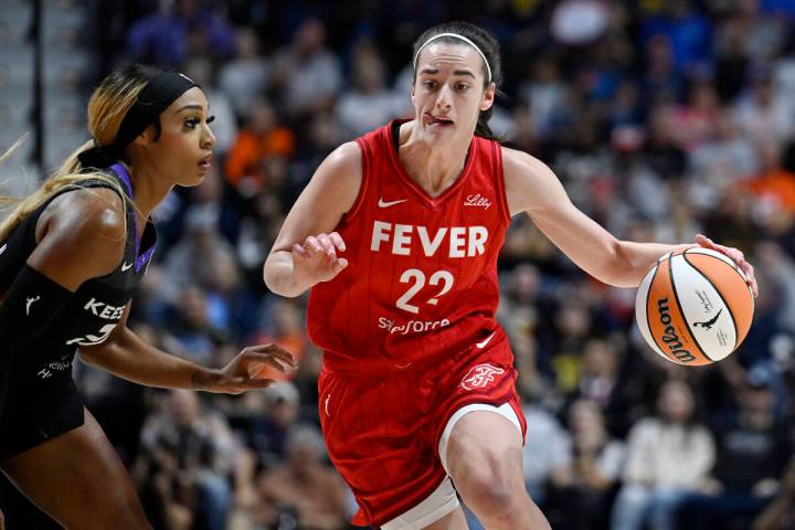 Indiana Fever guard Caitlin Clark (22) drives to the basket as Connecticut Sun guard DiJonai Ca ...