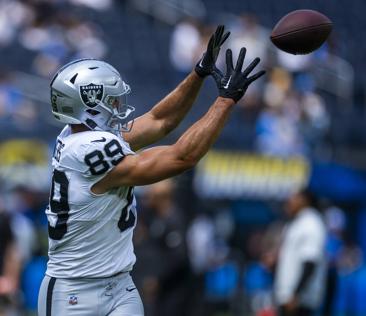 Raiders tight end Brock Bowers (89) catches a pass as they warm up to face the Los Angeles Char ...