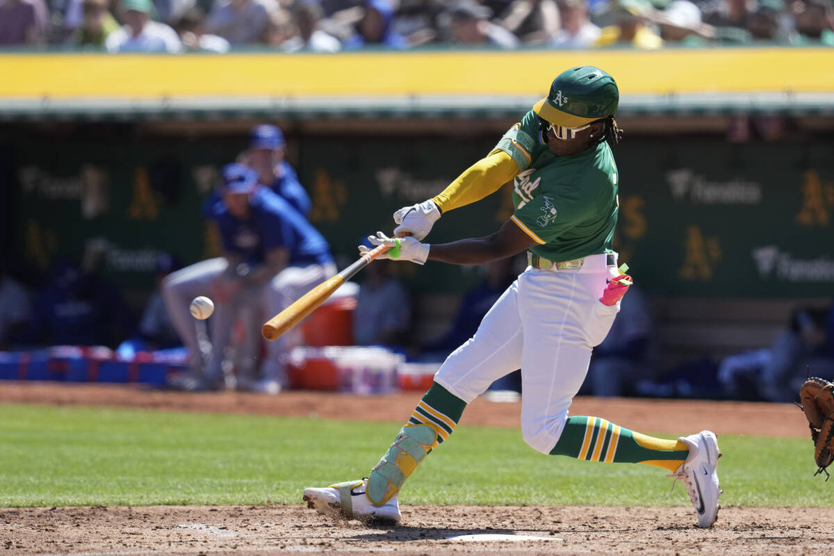 Oakland Athletics' Lawrence Butler hits a single during the third inning of a baseball game aga ...