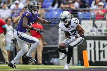 Raiders wide receiver Davante Adams (17) is unable to make a catch with Baltimore Ravens corner ...