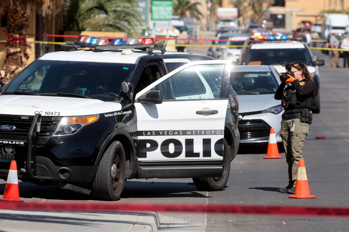 Las Vegas police investigate the scene of a officer-involved shooting on Deckow Lane near Tropi ...