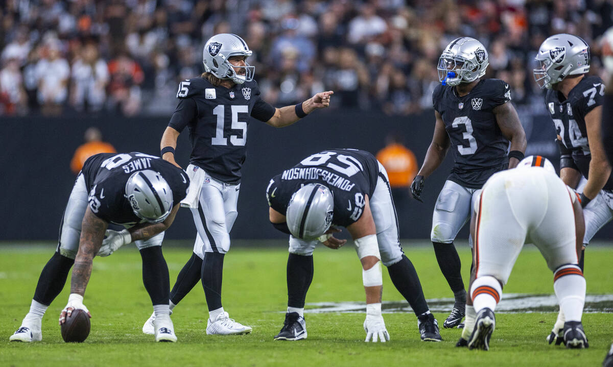 Raiders quarterback Gardner Minshew (15) changes a call with teammates against the Cleveland Br ...