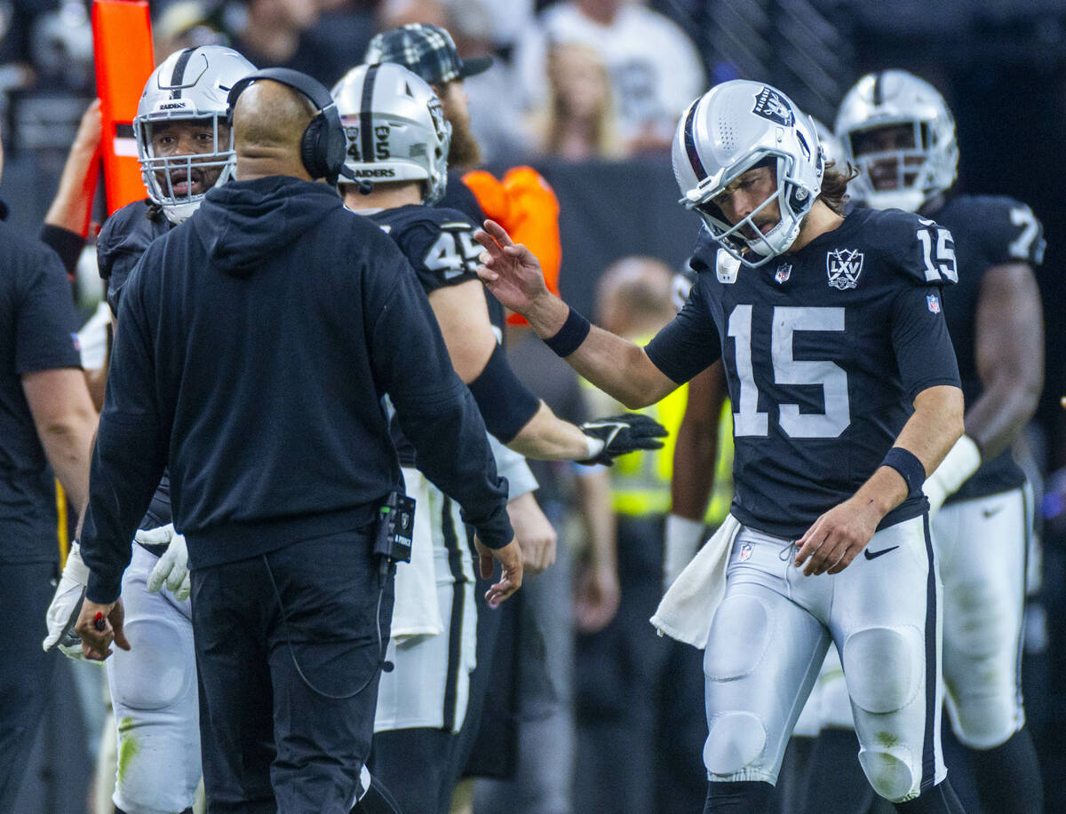 Raiders quarterback Gardner Minshew (15) attempts to stay upbeat after a running back fumble ag ...