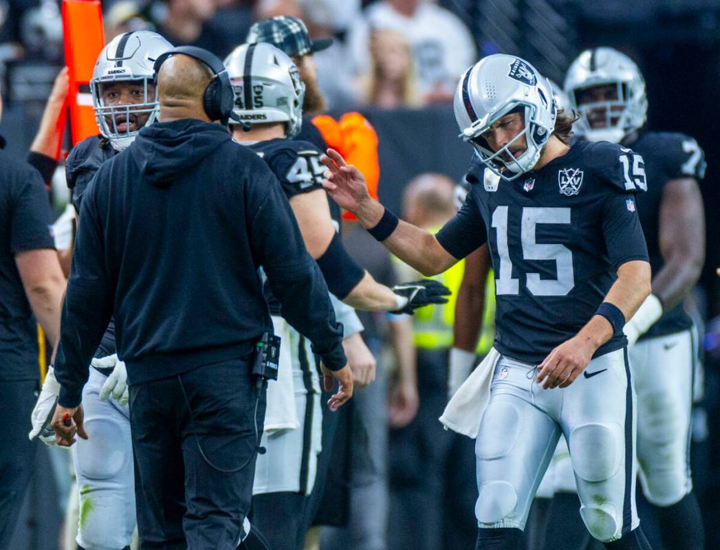 Raiders quarterback Gardner Minshew (15) attempts to stay upbeat after a running back fumble ag ...