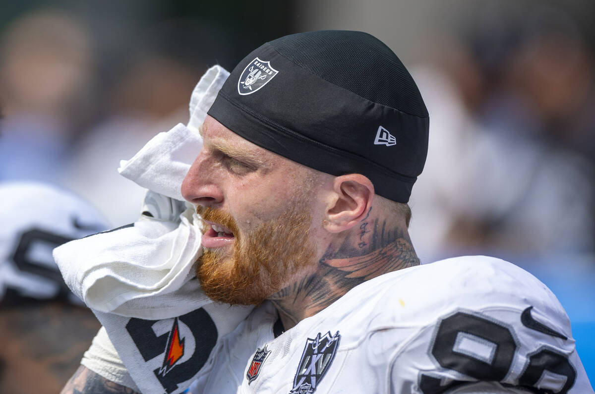 Raiders defensive end Maxx Crosby (98) towels down on the sidelines against the Los Angeles Cha ...