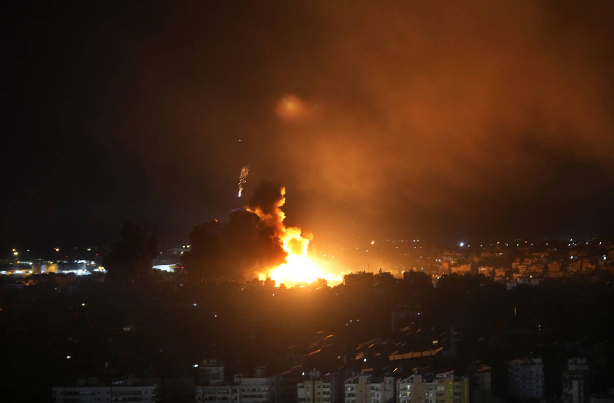 Flames rise from Israeli airstrikes in Dahiyeh, Beirut, Lebanon, Friday, Oct. 4, 2024. (AP Phot ...