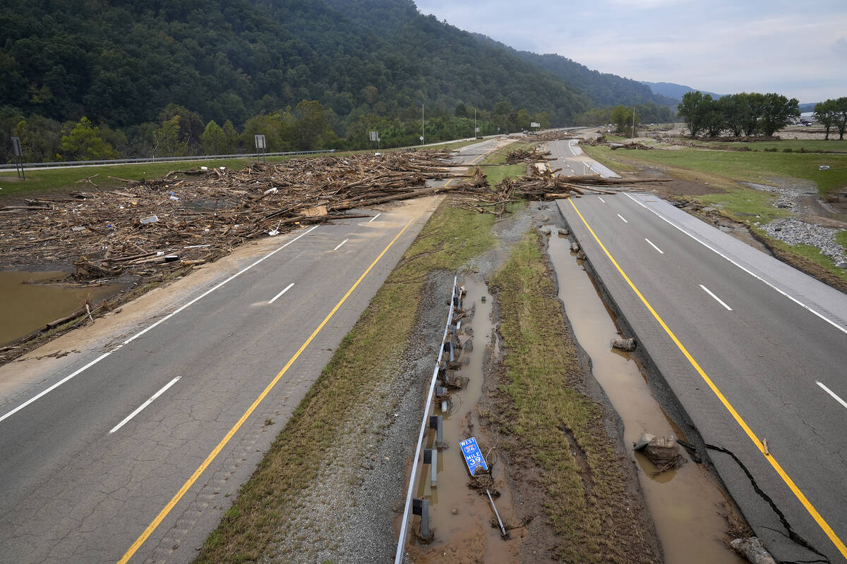 Debris covers the roadway along Interstate 26 in the aftermath of Hurricane Helene, Friday, Oct ...