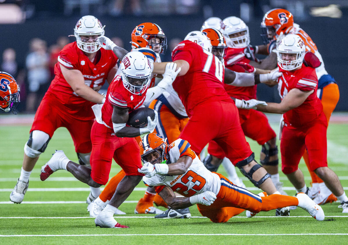 UNLV running back Jai'Den Thomas (9) slips a tackle by Syracuse Orange defensive back Devin Gra ...