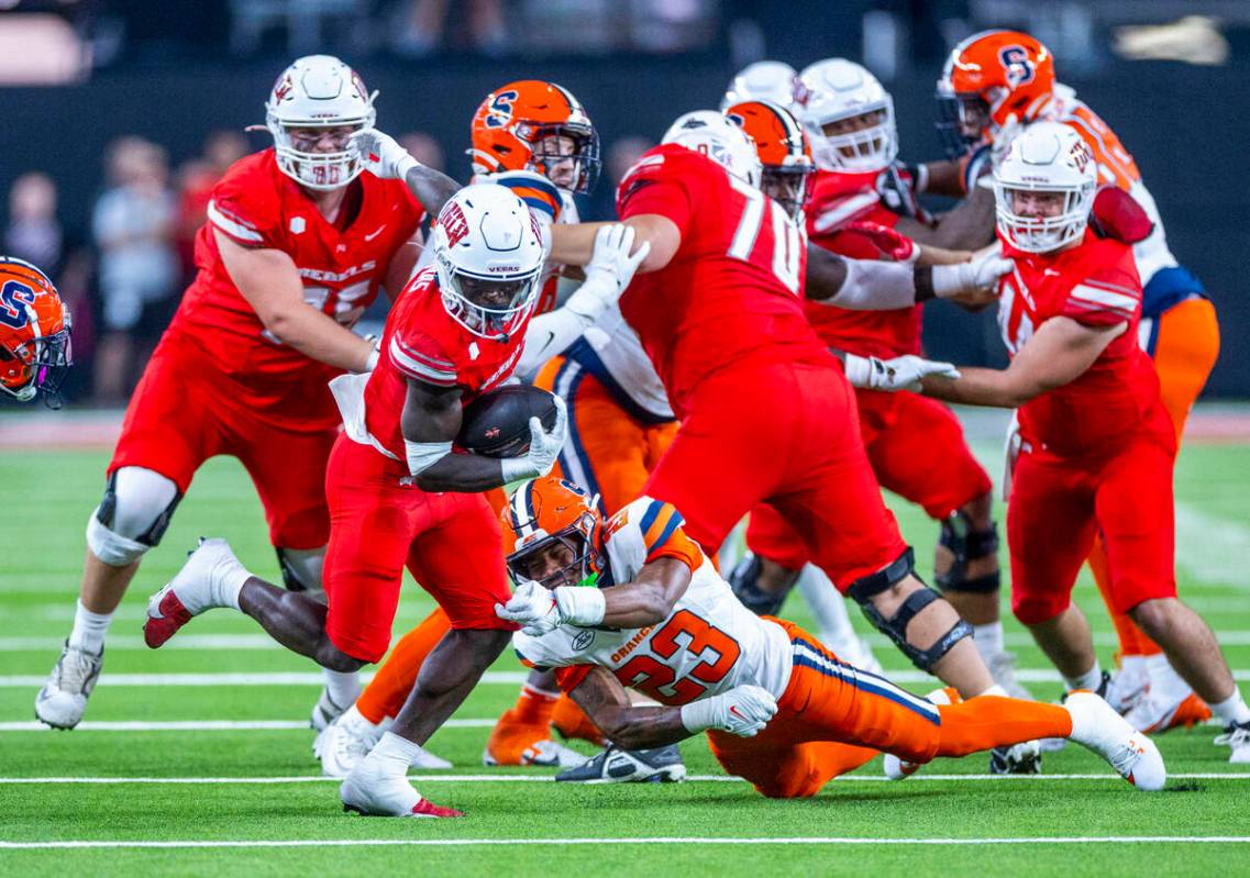 UNLV running back Jai'Den Thomas (9) slips a tackle by Syracuse Orange defensive back Devin Gra ...