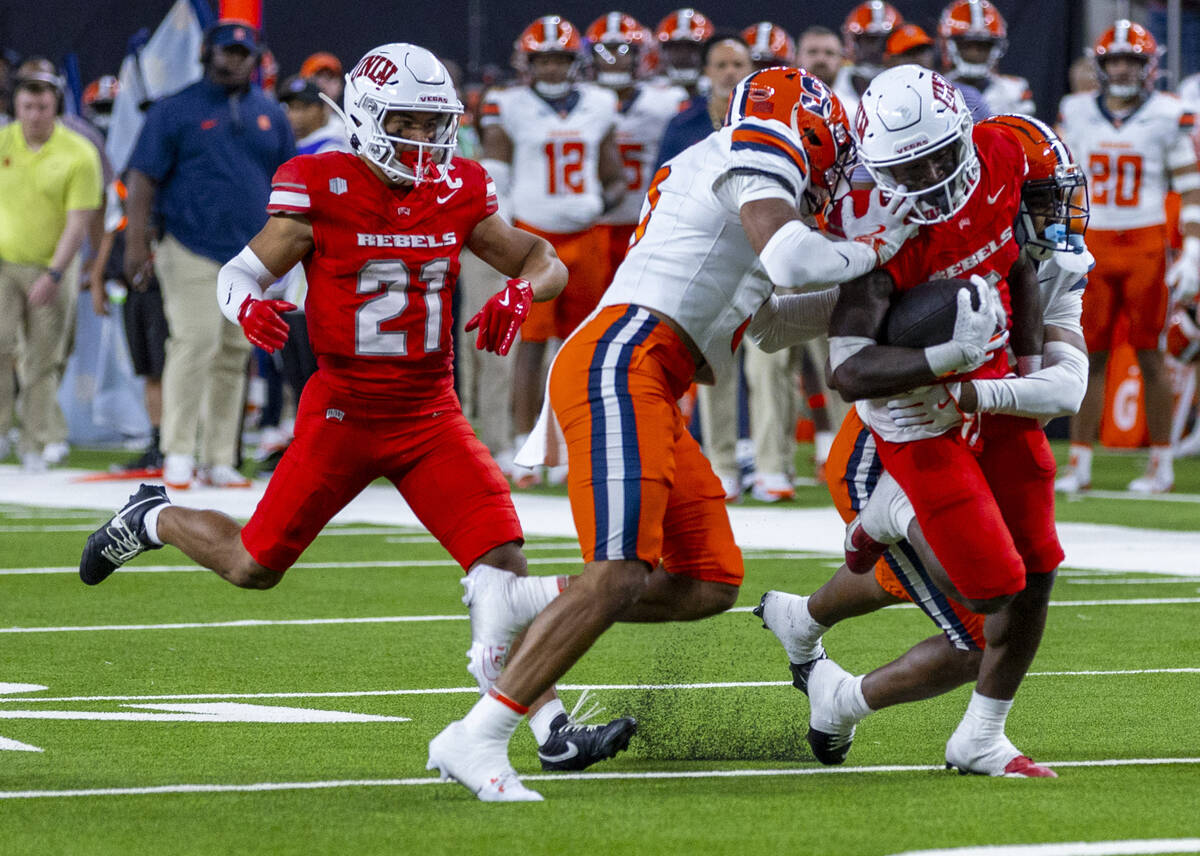 UNLV running back Jai'Den Thomas (9) battles for more yards against Syracuse Orange defensive b ...