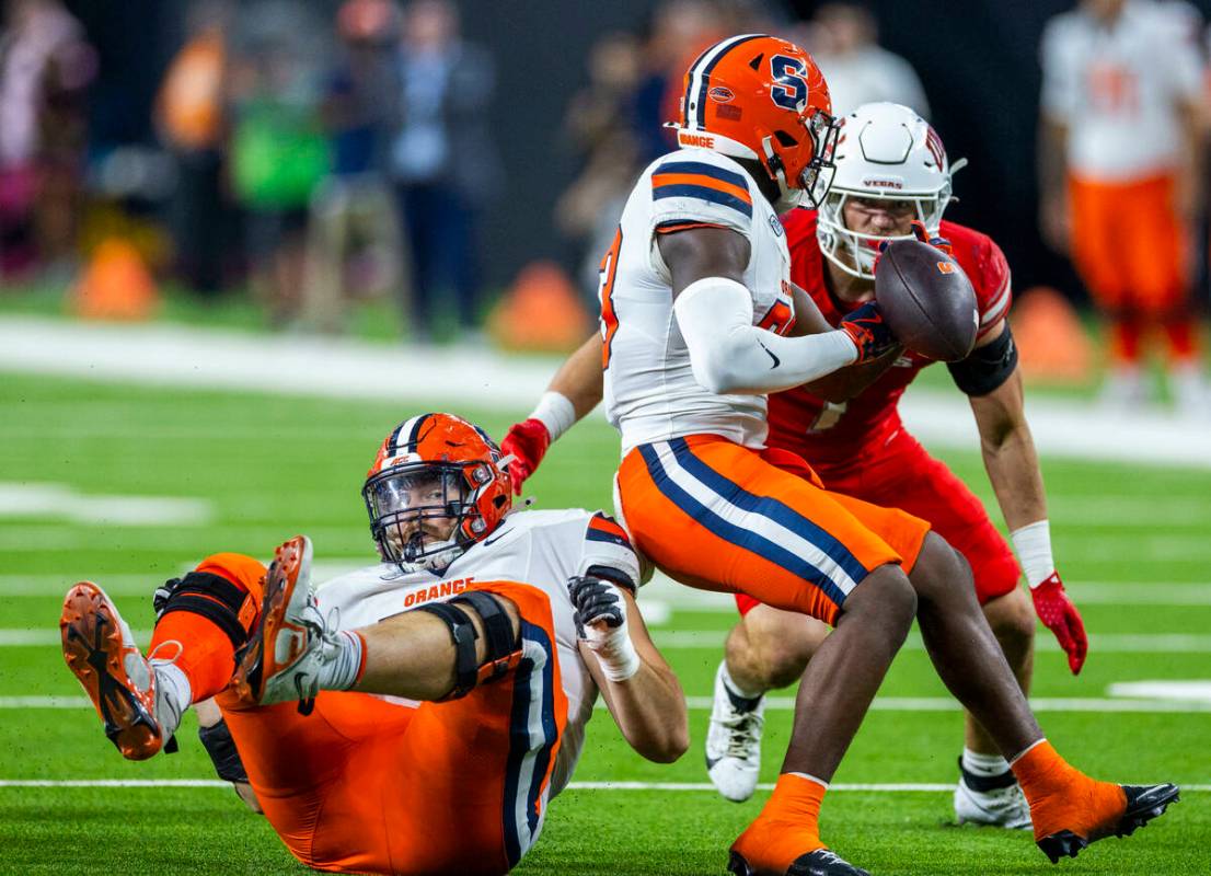 Syracuse Orange running back Yasin Willis (23) has the ball knocked away as UNLV defensive back ...