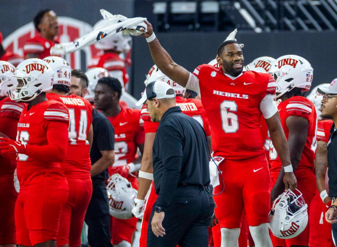 UNLV quarterback Hajj-Malik Williams (6) cheers for his defense while pumping up the crowd agai ...