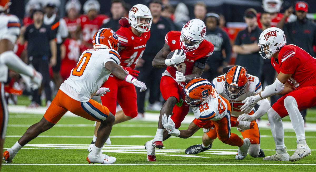 UNLV running back Jai'Den Thomas (9) is tackled by Syracuse Orange defensive back Devin Grant ( ...