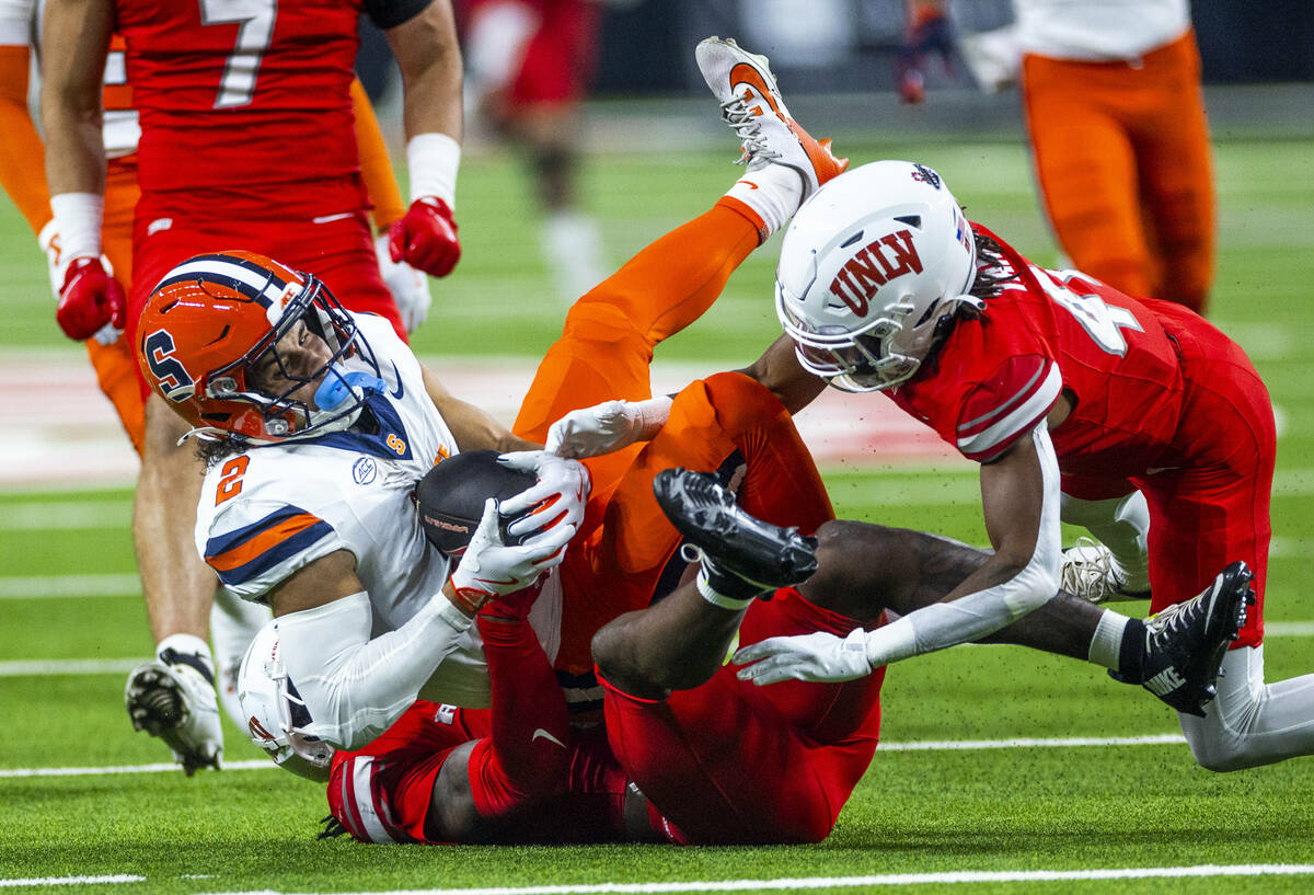 Syracuse Orange wide receiver Trebor Pena (2) is taken down by UNLV defensive back Rashod Tanne ...