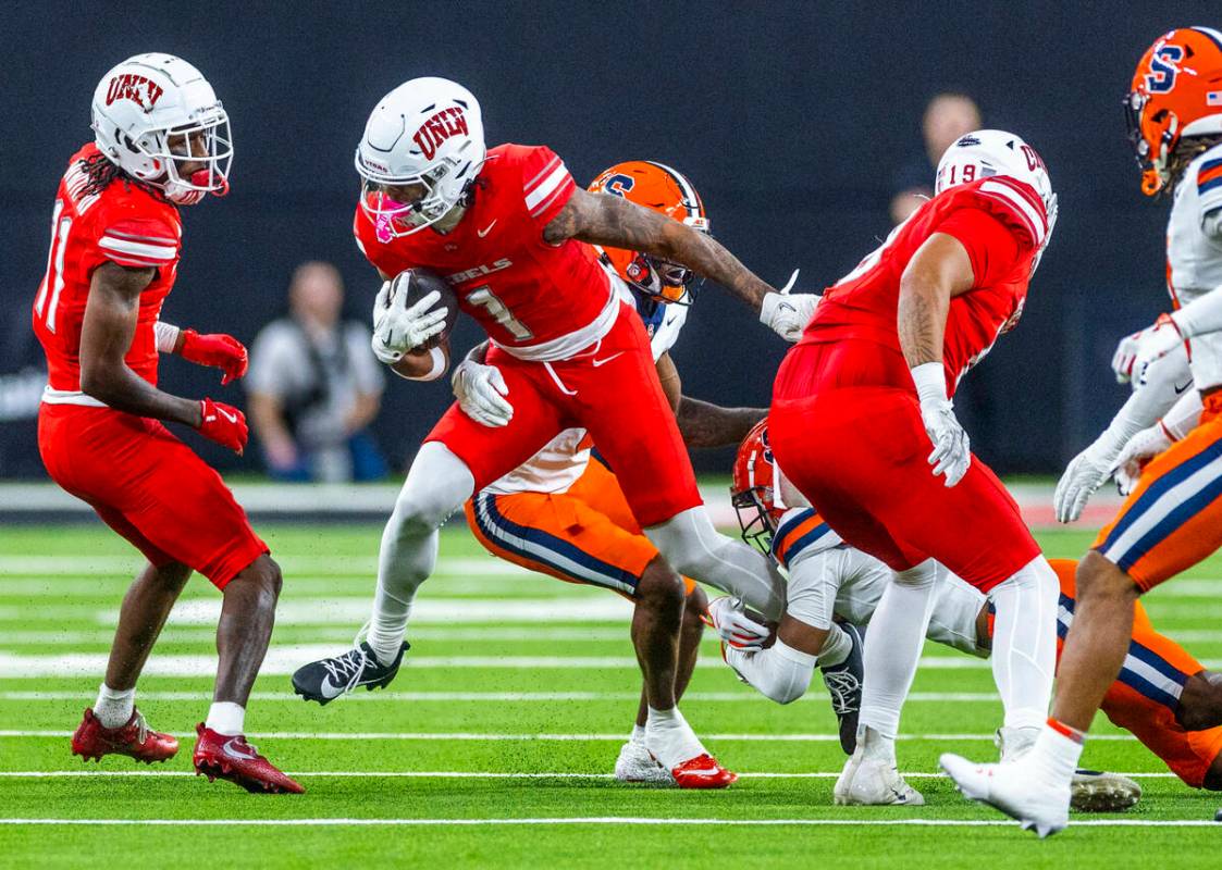 UNLV wide receiver Casey Cain (1) breaks a Syracuse Orange tackle attempt during the first half ...