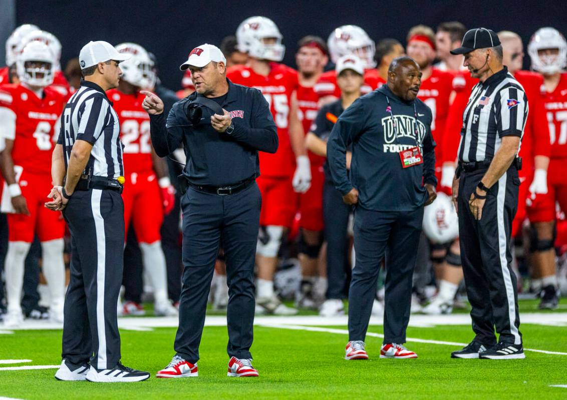 UNLV Head Coach Barry Odom argues a penalty with an official against the Syracuse Orange during ...