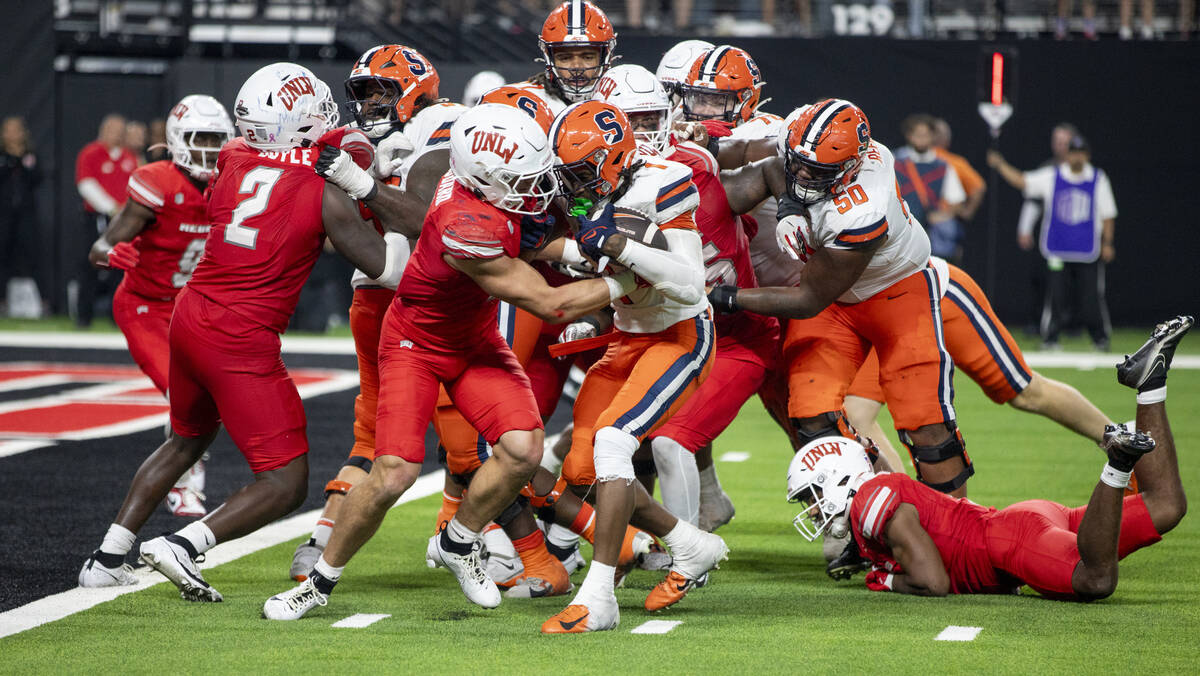 UNLV linebacker Jackson Woodard (7) attempts to tackle Syracuse Orange running back LeQuint All ...