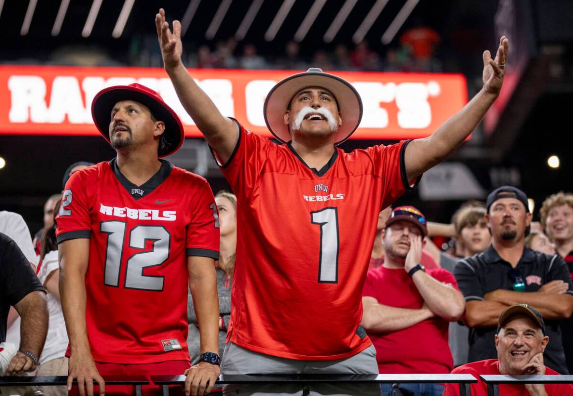 UNLV fans dressed as rebels become upset after a flag is thrown in overtime during the college ...