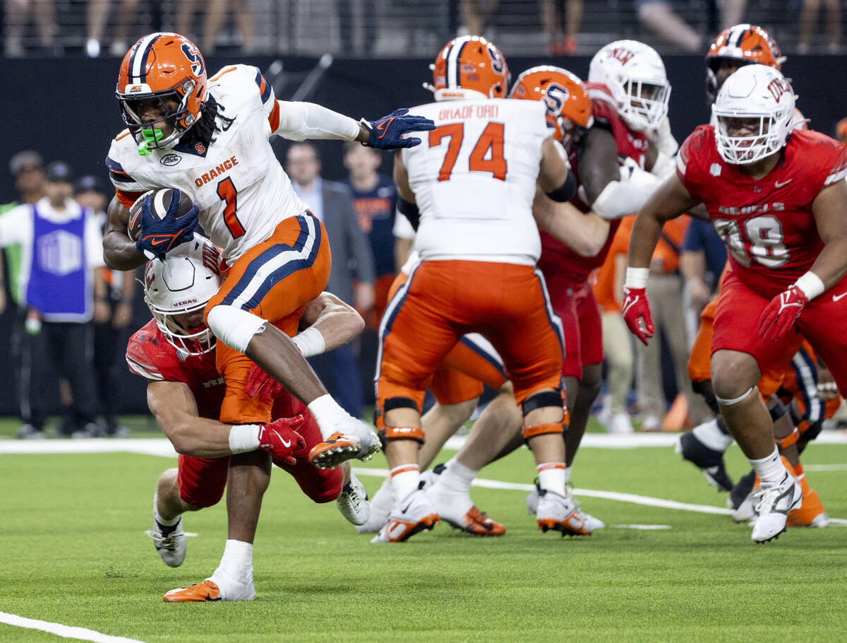 UNLV linebacker Jackson Woodard (7) tackles Syracuse Orange running back LeQuint Allen Jr. (1) ...