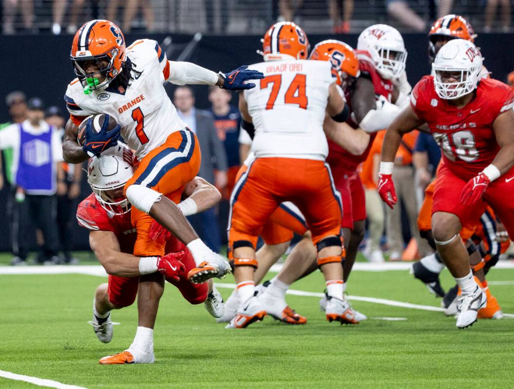 UNLV linebacker Jackson Woodard (7) tackles Syracuse Orange running back LeQuint Allen Jr. (1) ...