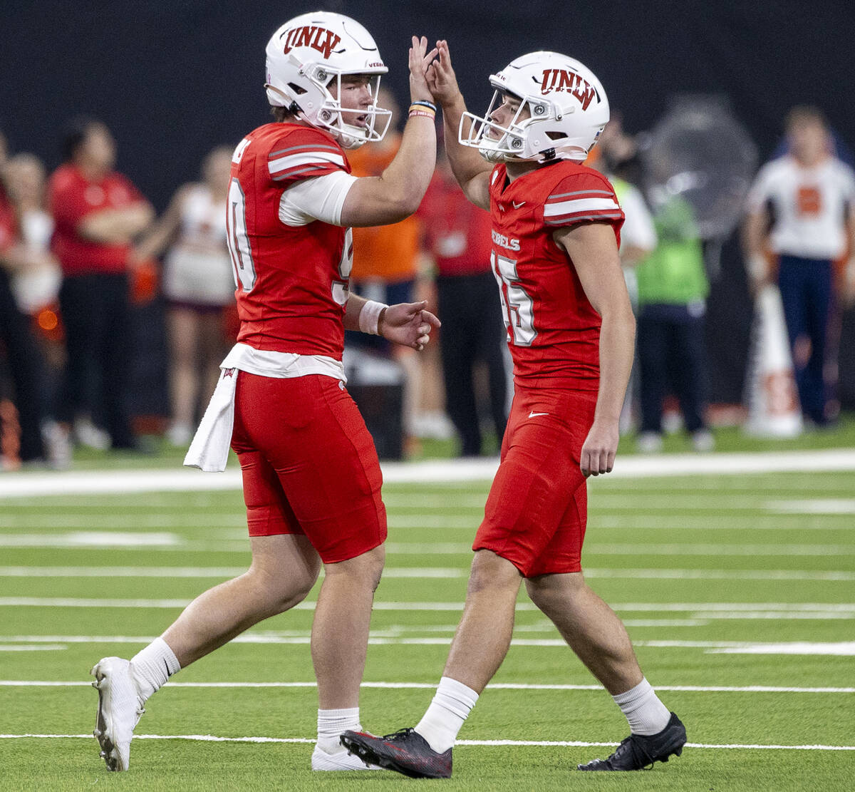 UNLV punter Marshall Nichols (90) and UNLV place kicker Caden Chittenden (45) celebrate a field ...